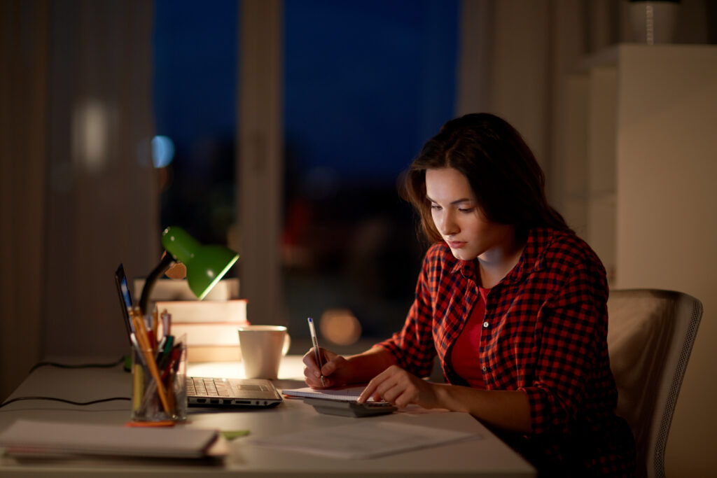 Your Pathway from International Student to Resident in Nova Scotia 9 people education freelance learning concept student girl with notebook calculator doing math home night